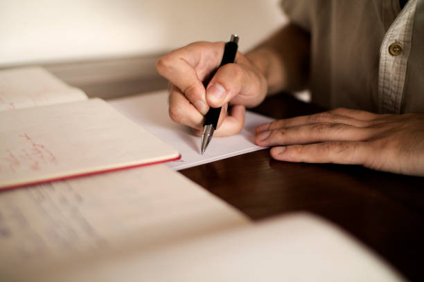 istock man writing by hand with ballpoint pen 1336641924