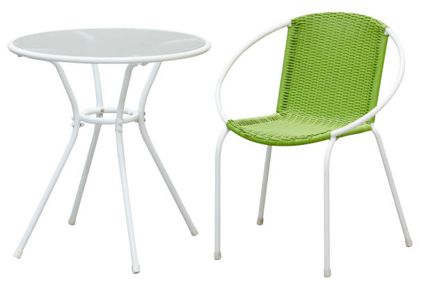 Green rattan chairs and small white round tables on a white background