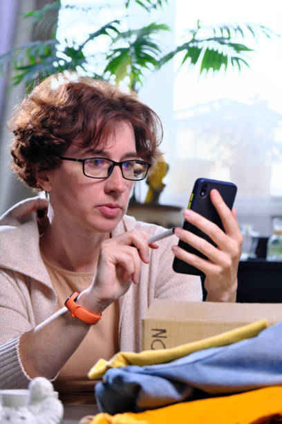 istock Mature woman is prepping donations at home 1336643464