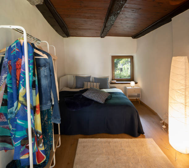 istock Front view bedroom with double bed, bedside table with a lamp above and a wardrobe on the left 1336645894