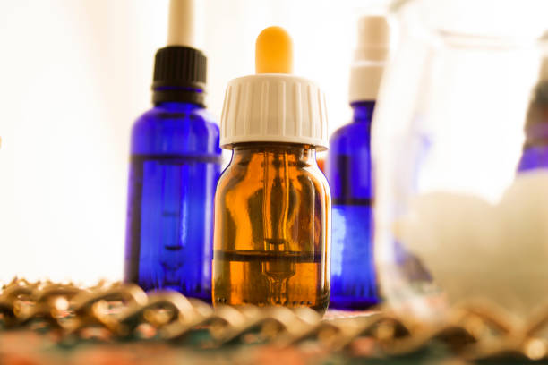 istock three flasks with pipettes, candles and gold chain 1336646269