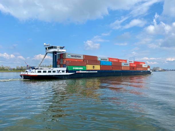 Inland shipping transport sailing pass Dordrecht stock photo