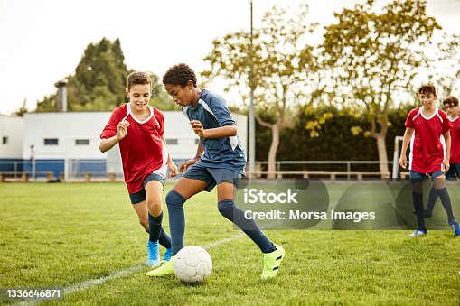 istock Teenagers practicing soccer in sports field 1336646871