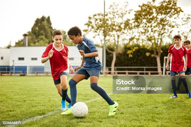 Teenagers Practicing Soccer In Sports Field Stock Photo - Download Image Now - Soccer, Child, Soccer Ball