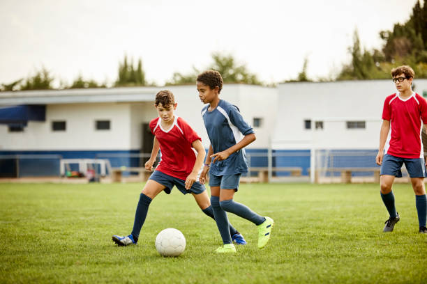 istock Teenage boys practicing soccer in training ground 1336646904
