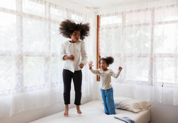istock Children jumping tegother on the bed. 1336646938