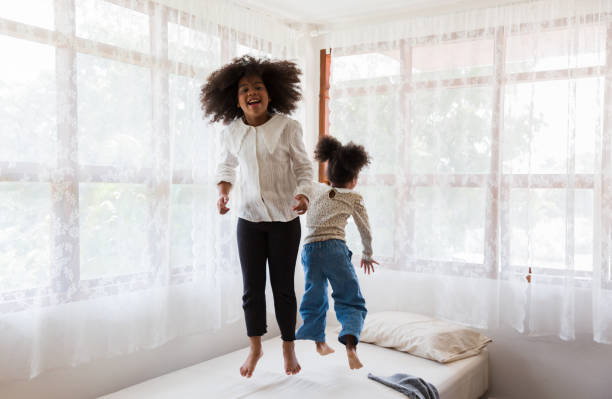 istock Children jumping on the bed. 1336646944