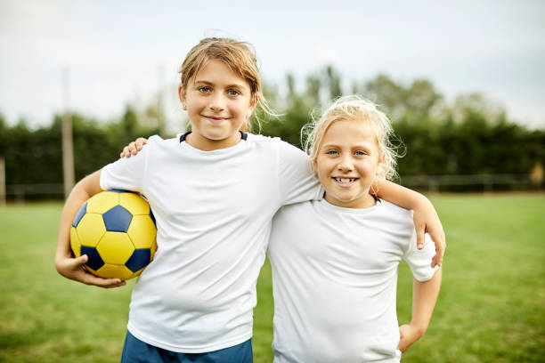 Portrait of girls with soccer ball in field Portrait of confident girls with ball in field. Smiling female players learning soccer. They are in sportswear. 9 stock pictures, royalty-free photos & images