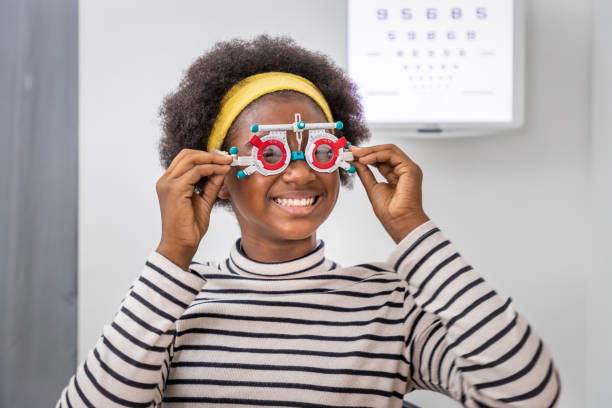 istock African young woman girl doing eye test checking examination using trial frame in clinic or optical shop. Eyecare concept. 1336647231