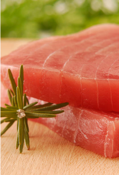 istock Sliced fresh tuna fish and Rosemary ingredient. 1336647254