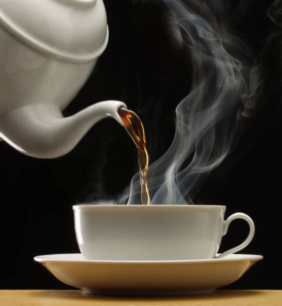 istock Pouring hot coffee on cup on black 1336647358