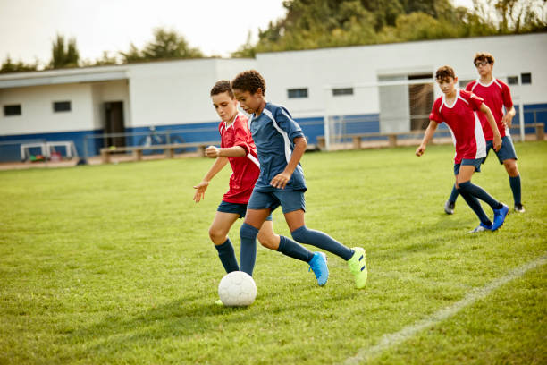 istock Teenagers practicing soccer in training ground 1336647565