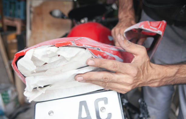 istock Preparation for painting a motorcycle. Hand in a sandpaper 1336647793