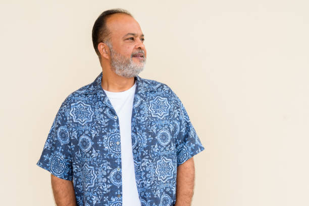 istock Portrait of handsome bearded Indian man against plain wall 1336648546