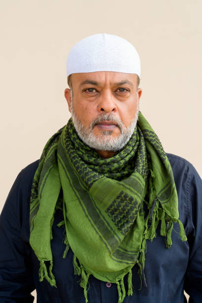 istock Portrait of handsome bearded muslim man against plain wall 1336648558