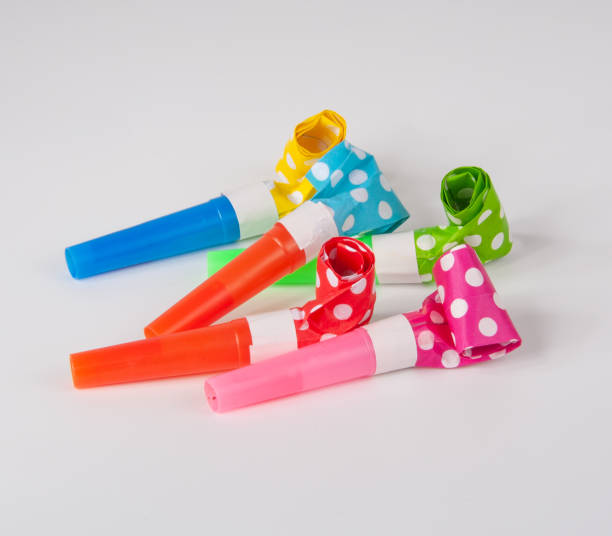 istock Rolled festive noisemaker or party whistle on the white 1336651055