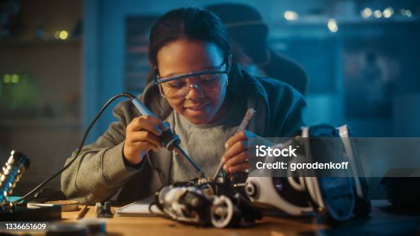 Young Teenage Multiethnic Schoolgirl Is Studying Electronics And Soldering Wires And Circuit Boards In Her Science Hobby Robotics Project Girl Is Working On A Robot In Her Room Education Concept Stock Photo - Download Image Now