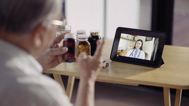 istock Senior man making video call with his doctor while staying at home 1336652328