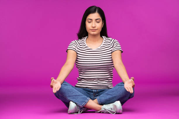 istock Young woman on purple background 1336652352