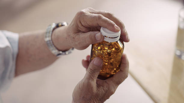 istock Senior man taking food supplements and vitamins capsules 1336652400