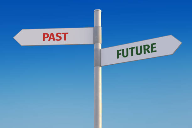 istock Past vs. future concept. Two street signs pointing into opposite directions. Looking forward or looking backwards 1336653267
