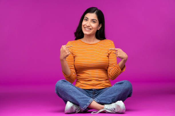 istock Young woman on purple background 1336654135