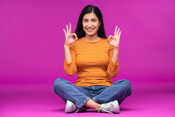 istock Young woman on purple background 1336654290
