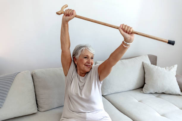 istock Happy elderly woman holding walking stick wooden cane accessory. 1336654321