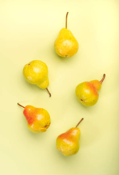 istock Red yellow pears, autumn harvest, light green background, top view 1336654658