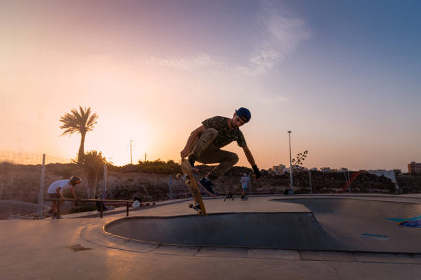 istock young skateboarder jumps in a skate park at sunset 1336655423