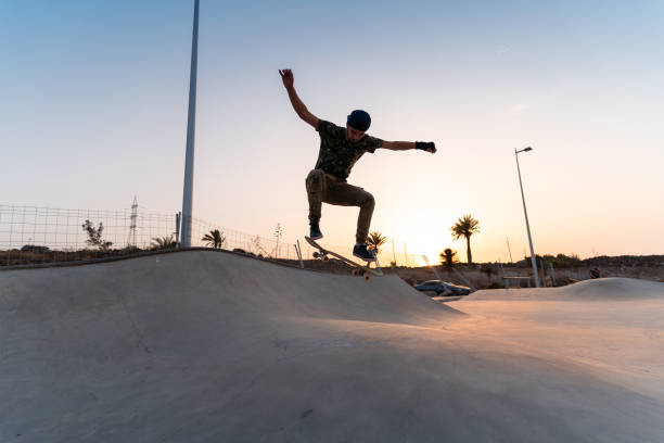 istock young skater man does a trick called ollie at sunset. movement 3 1336655468