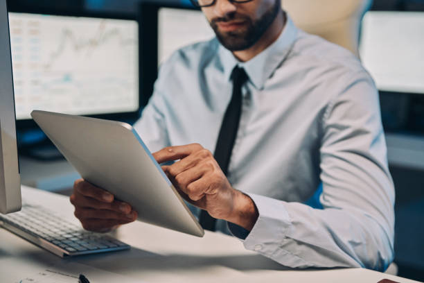 istock Close up of concentrated young man working on digital tablet 1336658250