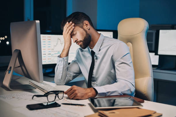 istock Frustrated young man in shirt and tie having headache 1336658384