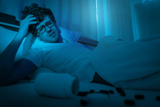 istock tired caucasian male having stressed problem with sleeping pill medication for insomnia treatment. 1336660526