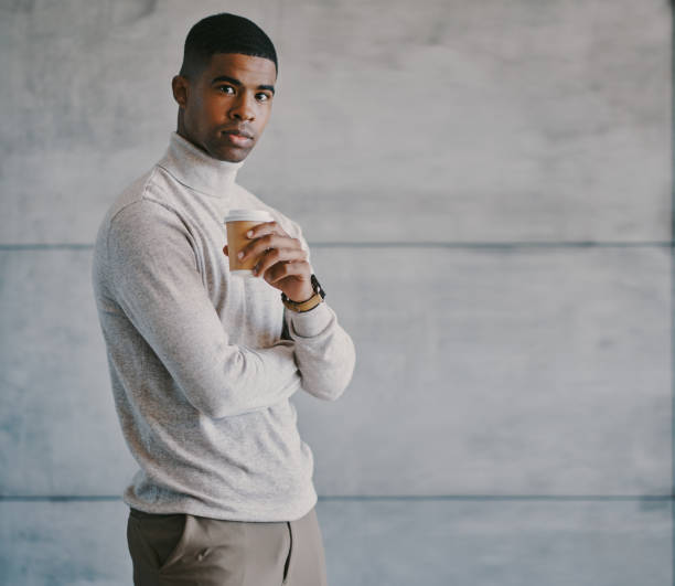istock Shot of a young businessman drinking coffee at work 1336661644