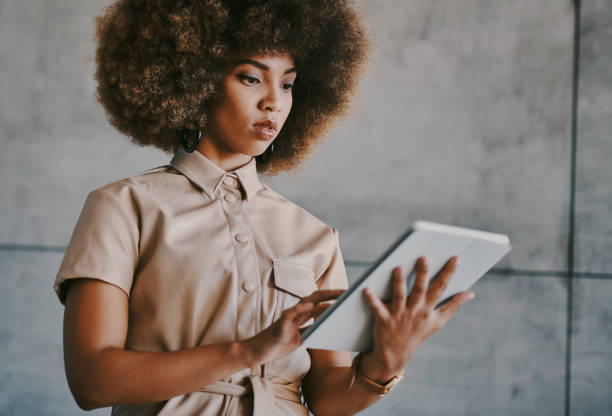 istock Shot of a young businesswoman using her digital tablet at work 1336661988