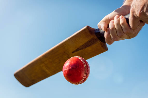 istock Cricket player batsman hitting a ball with a bat shot from below background 1336662683