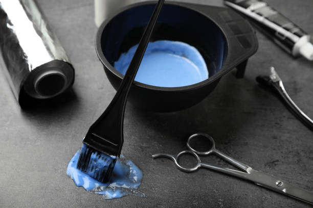 istock Professional tools for hair dyeing on grey stone background 1336662911