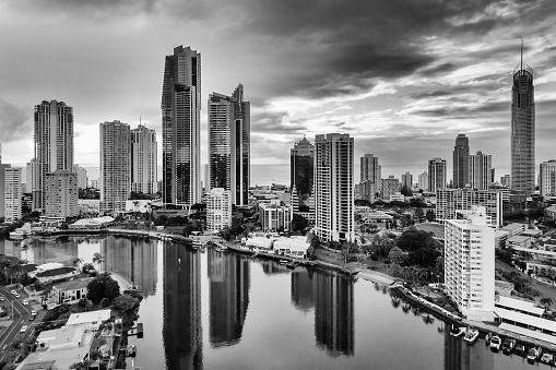 Cloudy black-whtie cityscape of high-rise towers in Surfers paradise city of Australian Gold Coast - aerial view to Pacific ocean from Nerang river.