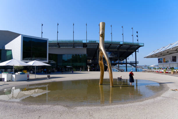 Little pond with golden sculpture and opera open air arena in the background. Photo taken August 14th, 2021, Bregenz, Austria.