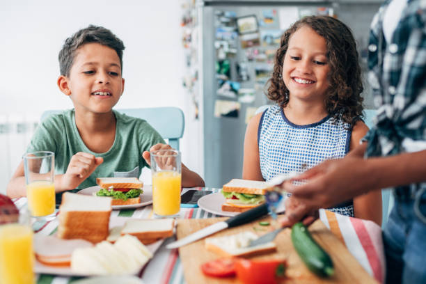 istock Happy family having breakfast in kitchen at home 1336668873