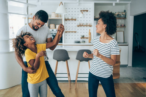 istock Family dancing in living room. 1336668924