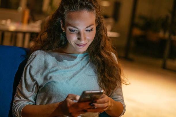 istock Young woman using smart phone at night. 1336668940