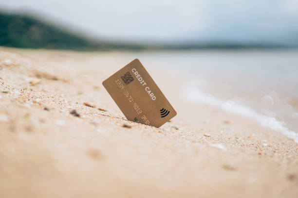 istock Credit card in the sand on the beach 1336668957