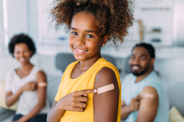 Family showing their arms after getting vaccinated.