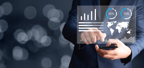istock man holding phone with finance icons 1336672502