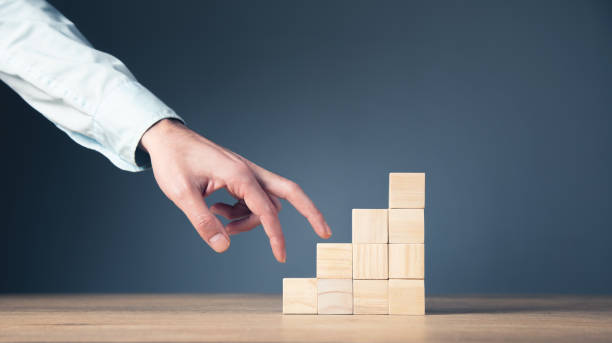 istock man climbs the wooden stairs 1336672856