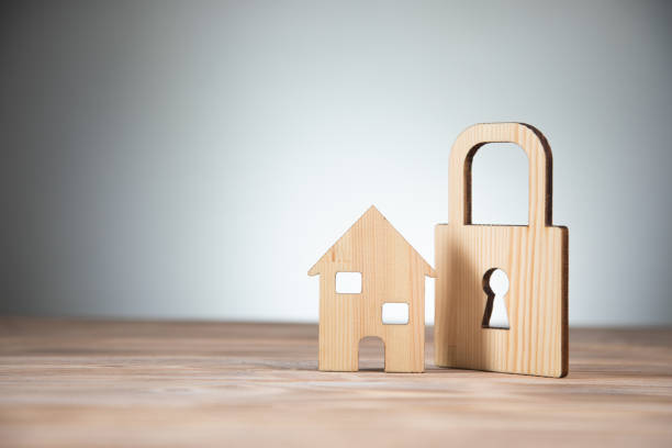 istock wooden house model with lock 1336672880