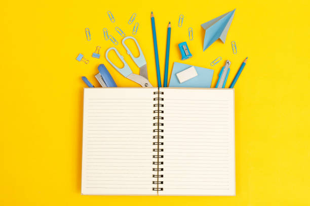 istock Top view notebooks and accessories stationery studying in the library at school yellow background idea education 1336676702