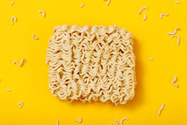 Top view instant noodles on yellow background stock photo